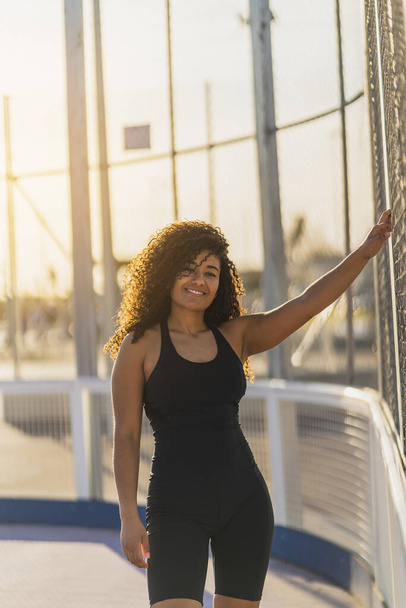 young african american woman with afro hair in sportswear posing in the city - Photo, image