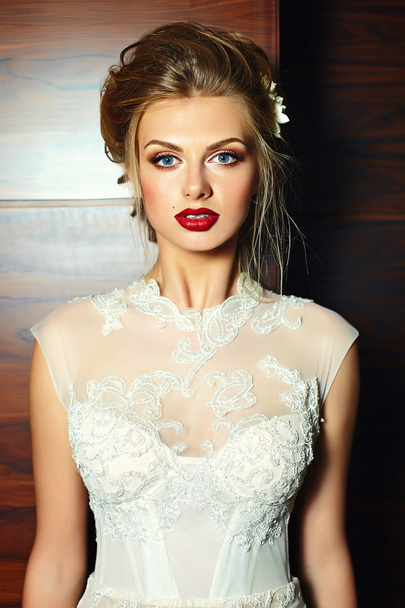 High fashion look.glamor closeup portrait of beautiful sexy stylish  blond bride young woman model with bright makeup, with red lips,  with perfect clean skin in wedding dress - Fotó, kép