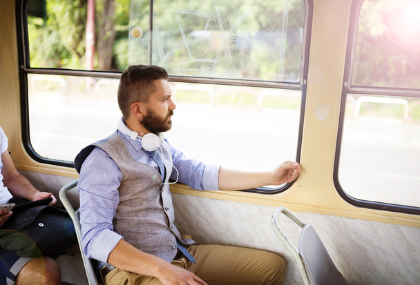 Man with headphones traveling by tram - Foto, afbeelding