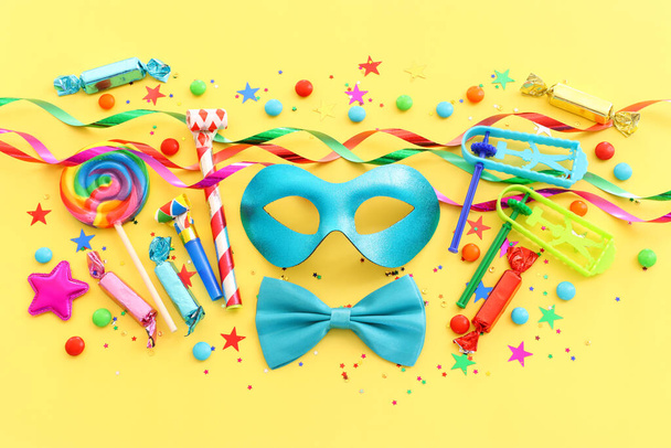 Purim celebration concept (jewish carnival holiday) over yellow background - Фото, зображення