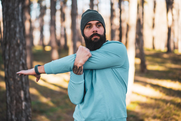 Man with beard enjoys exercising in nature. - Φωτογραφία, εικόνα