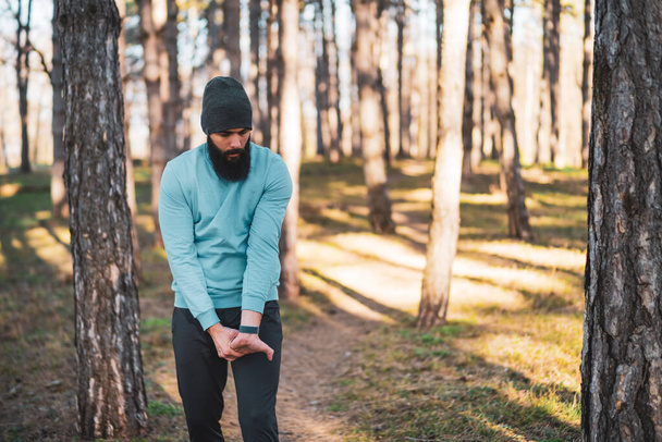 Man with beard enjoys exercising in nature. - 写真・画像
