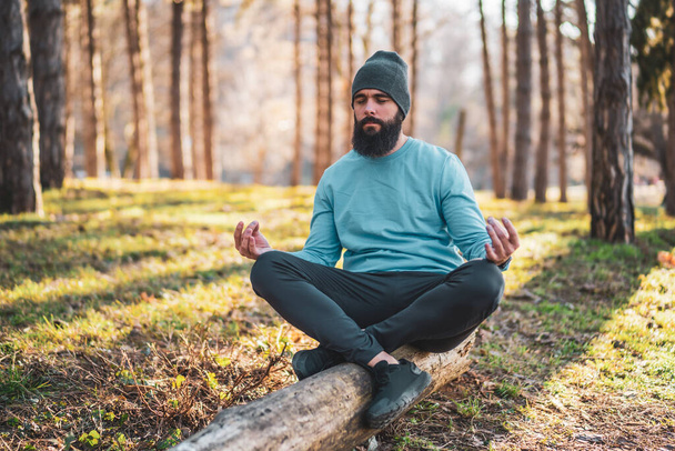 Sporty man enjoys meditating in the nature. - Fotografie, Obrázek