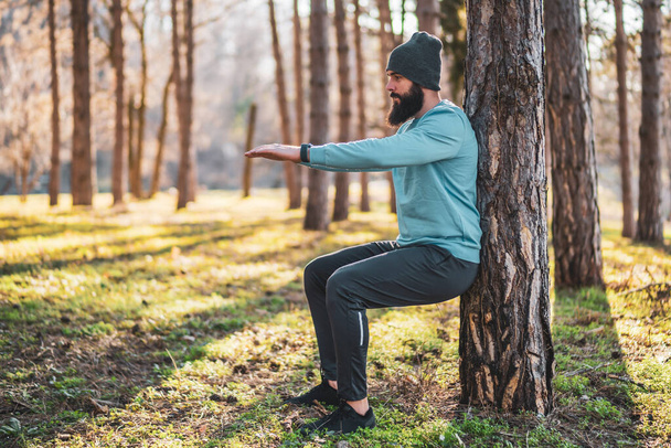 Man with beard enjoys exercising in nature. - Fotografie, Obrázek