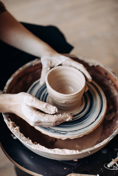 The place of work of a potter. Potter makes a jug - Photo, image