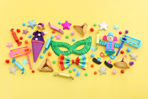 Purim celebration concept (jewish carnival holiday) over yellow background. Top view, flat lay - Fotografie, Obrázek