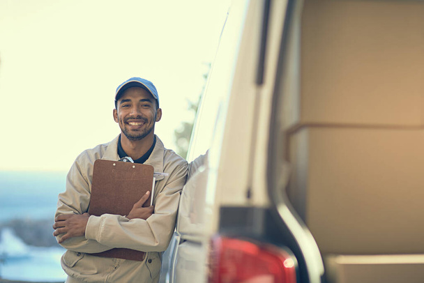 Our service has been rated as the most reliable. Portrait of a delivery man standing next to his van. - Zdjęcie, obraz