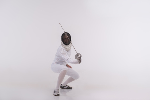 Young woman engaging in fencing - Φωτογραφία, εικόνα
