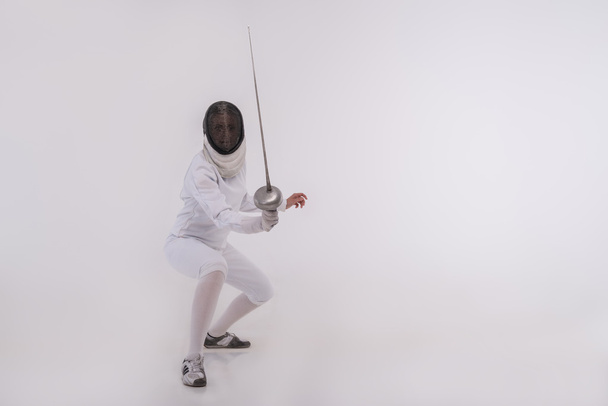 Young woman engaging in fencing - Foto, Imagen