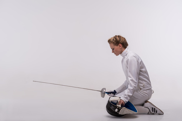 Young woman engaging in fencing - Фото, зображення