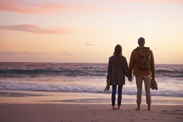 Life is perfect when Im with you. Shot of a couple enjoying a romantic evening on the beach at sunset. - Foto, immagini