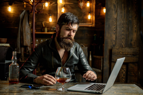 Bearded business man with glass of whiskey. Stressed from hard work. - Zdjęcie, obraz