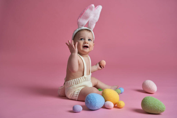 Cute little baby wearing bunny costume looking away - Foto, afbeelding