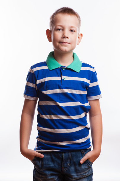 Young pretty boy posing at studio as a fashion model. Photo of preschooler 7 years old over white background - Foto, Imagen