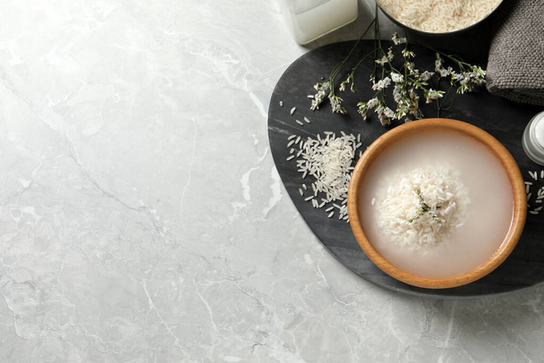 Flat lay composition with soaked rice and grains on light grey marble table. Space for text - Foto, imagen