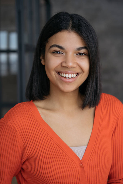 Beautiful confident African American woman with toothy smile looking at camera. Portrait of happy successful student. Education concept - Photo, Image