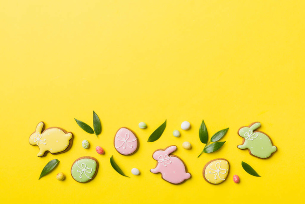 holiday preparation Multi colors Easter eggs with cookies on colored background . Pastel color Easter eggs. holiday concept with copy space. - Photo, Image