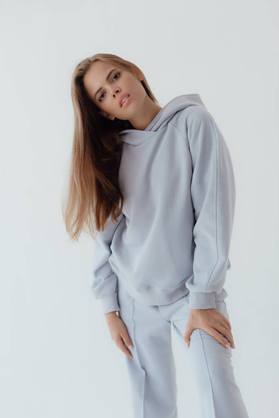 Ukrainian young woman in sweatshirt mock up on light background. Female body and style concept. Advertisement or clothes sale design. Mock up for design, clothes shop sale. Close up emotional woman - Photo, image