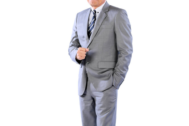 Businessman wearing an elegant suit over white background. Well-dressed senior man in the studio That emphasizes thoughtful thinking, thinking carefully - Foto, Imagen