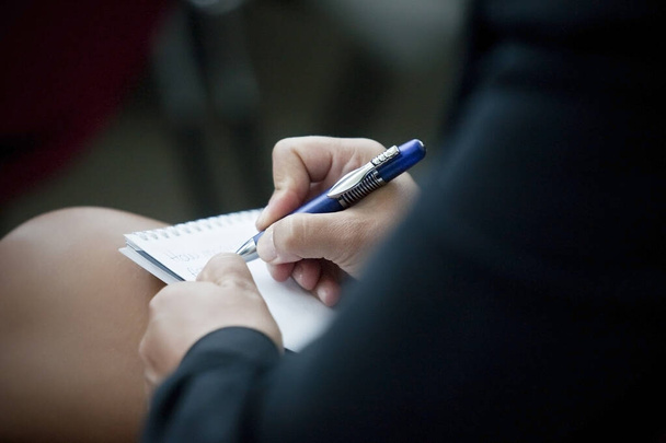 close up of a woman writing a pen on a notebook - Fotoğraf, Görsel