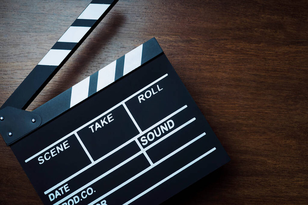 movie clapper cinema board or Slate film.Clapperboard for filmmaking and video production to assist in synchronizing of picture ,sound on Wooden Floor Tiles background.cinema concept - Photo, Image