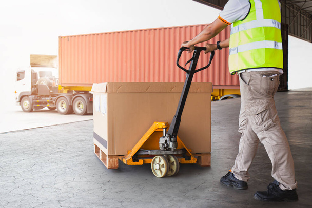 Worker Courier Unloading Package Boxes into Cargo Container. Delivery service. Truck Loading at Dock Warehouse. Shipments Supply Chain. Shipping Warehouse Logistics Transportation. - Фото, зображення
