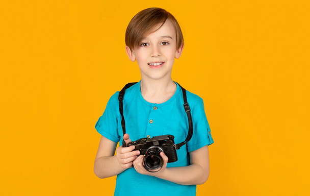 Boy using a cameras. Baby boy with camera. Cheerful smiling child holding a cameras. Little boy on a taking a photo using a vintage camera. Child in studio with professional camera - Zdjęcie, obraz