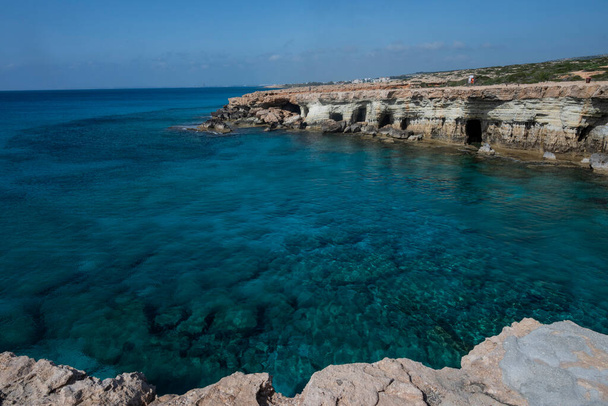 coast in ayia napa sea caves in cape greco in cyprus on the seashore with rocks - 写真・画像