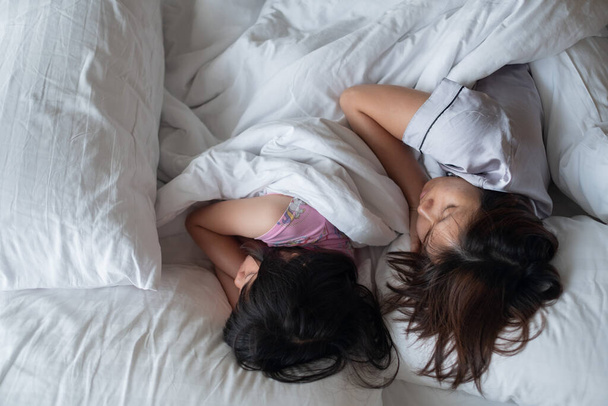 moeder en dochter slapen in be - Foto, afbeelding