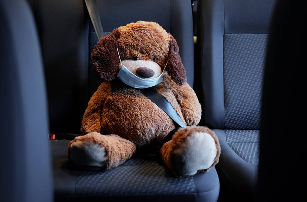 Safety first. Shot of a teddy bear on a car seat in a car. - Foto, Imagen