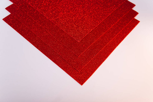 Red sheets of cardboard with sparkles on a white background. Materials for creativity - Fotó, kép