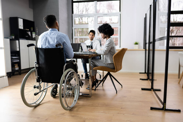 Disabled Mature Businessman Sitting At Desk With Laptop In Conference Room - Foto, Bild