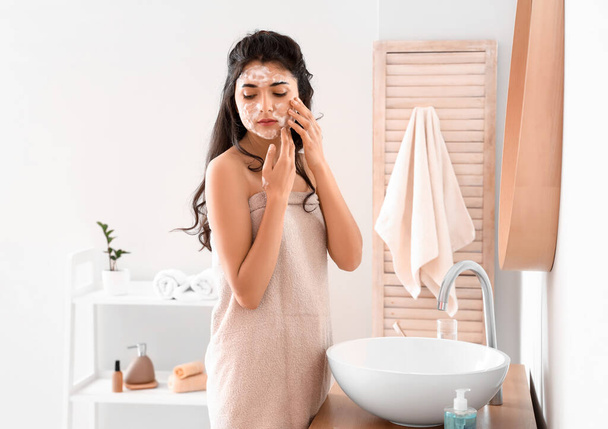 Morning of beautiful young woman washing face in bathroom - Foto, imagen