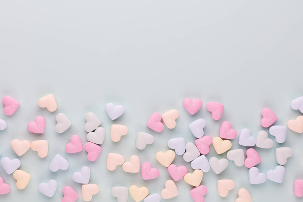 Valentine's Day background. Composition with candy hearts on pastel blue background. Valentines Day greating card. Flat lay, top view. - Foto, Imagem
