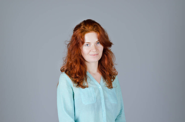 Business portrait of beautiful young woman with red curly hair and blue eyes against colorful background. Lifestyle.  - Φωτογραφία, εικόνα