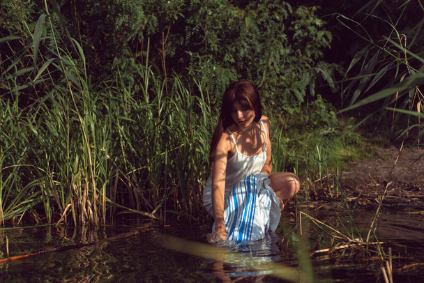 Young brunette woman on a sunny summer day - Valokuva, kuva