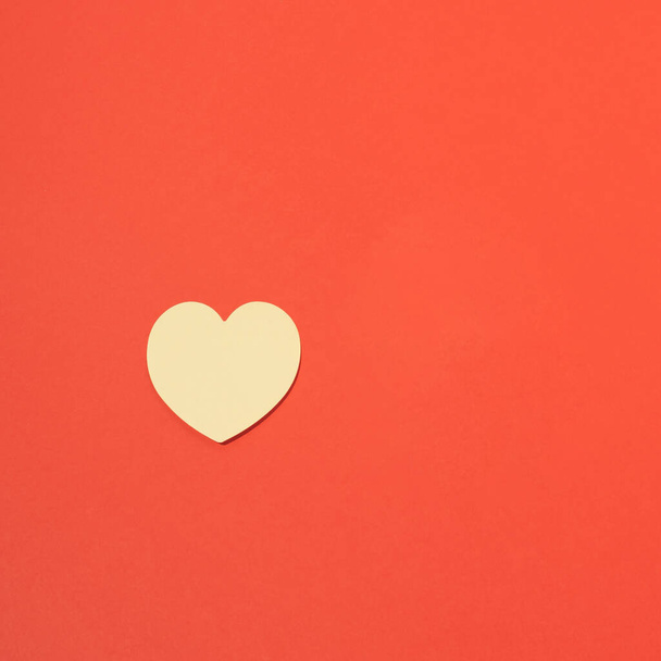 One  yellow paper heart on a red background.Minimalist Creative Design Concept. - Foto, Bild