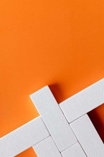 top view of white quadrangular blocks on orange background with copy space - Photo, Image
