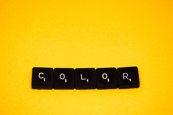 word" made of wooden letters on a yellow background - 写真・画像