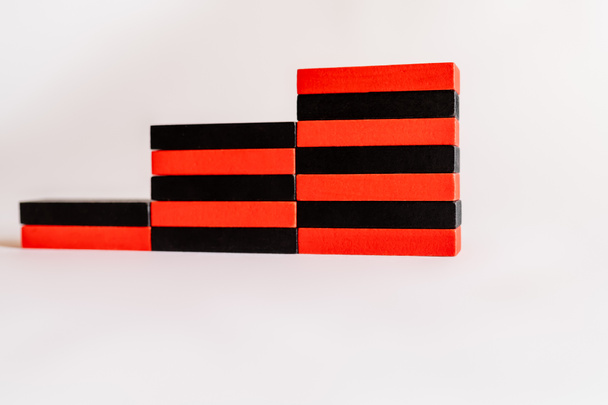 blocs rouges et noirs en forme d'escalier sur fond blanc - Photo, image