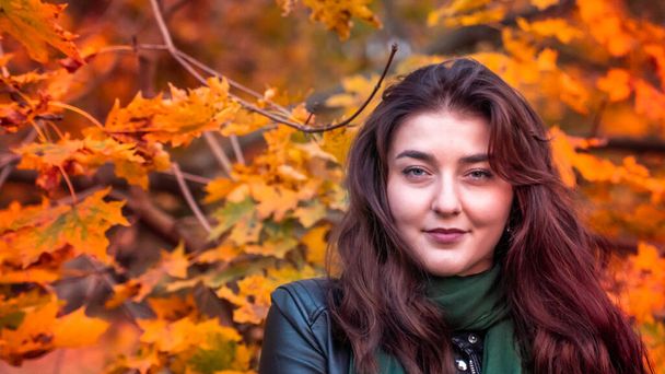fiatal nő a sállal pózol a kamerának az őszi parkban - Fotó, kép