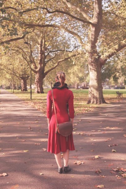 Young woman walking in the park - Фото, зображення
