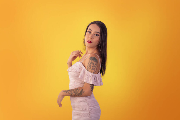 Gama,Distrito Federal, October 16, 2021,  young woman in short dress in sexy poses on a yellow background. - Fotografie, Obrázek