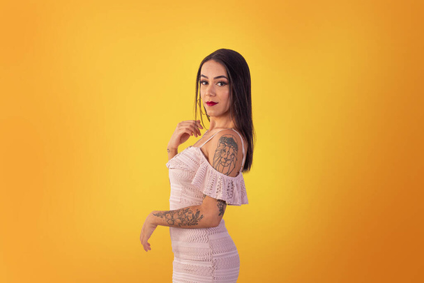 Gama, Distrito Federal, lokakuu 16, 2021, nuori nainen lyhyt mekko seksikäs aiheuttaa keltaisella taustalla. - Valokuva, kuva