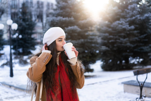 aesthetic photo of a young girl walking the streets of the city with hot coffee - Фото, зображення