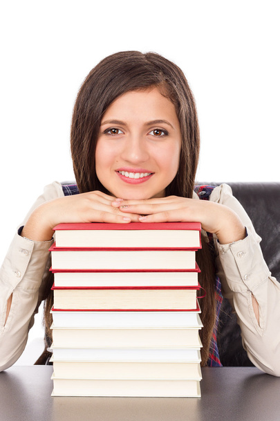 Closeup of student holding her head on a  stack of books  - Фото, зображення