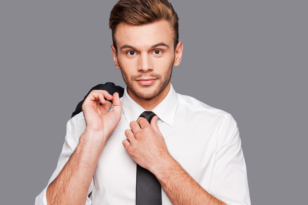 Man in formalwear adjusting his necktie - Fotografie, Obrázek