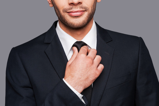 Man in formalwear adjusting his necktie - Фото, изображение