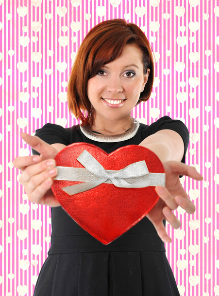 Beautiful red hair woman holding heart shape box anniversary box - Photo, Image