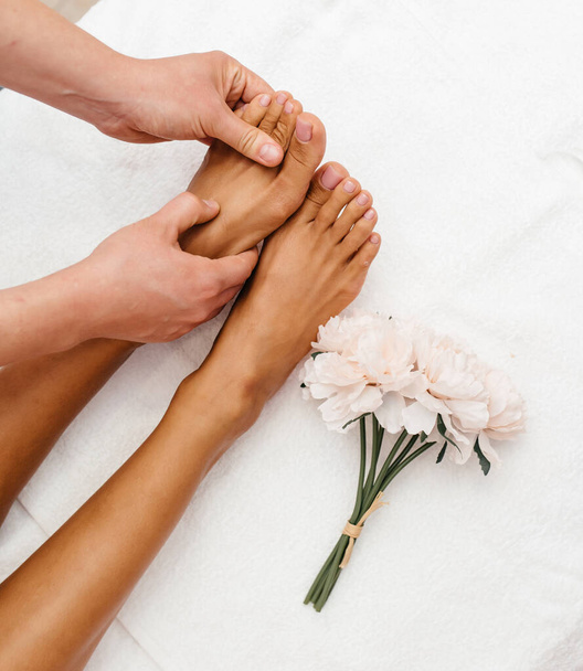 Woman with beautiful feet on white towel, closeup. Spa treatment - Photo, Image